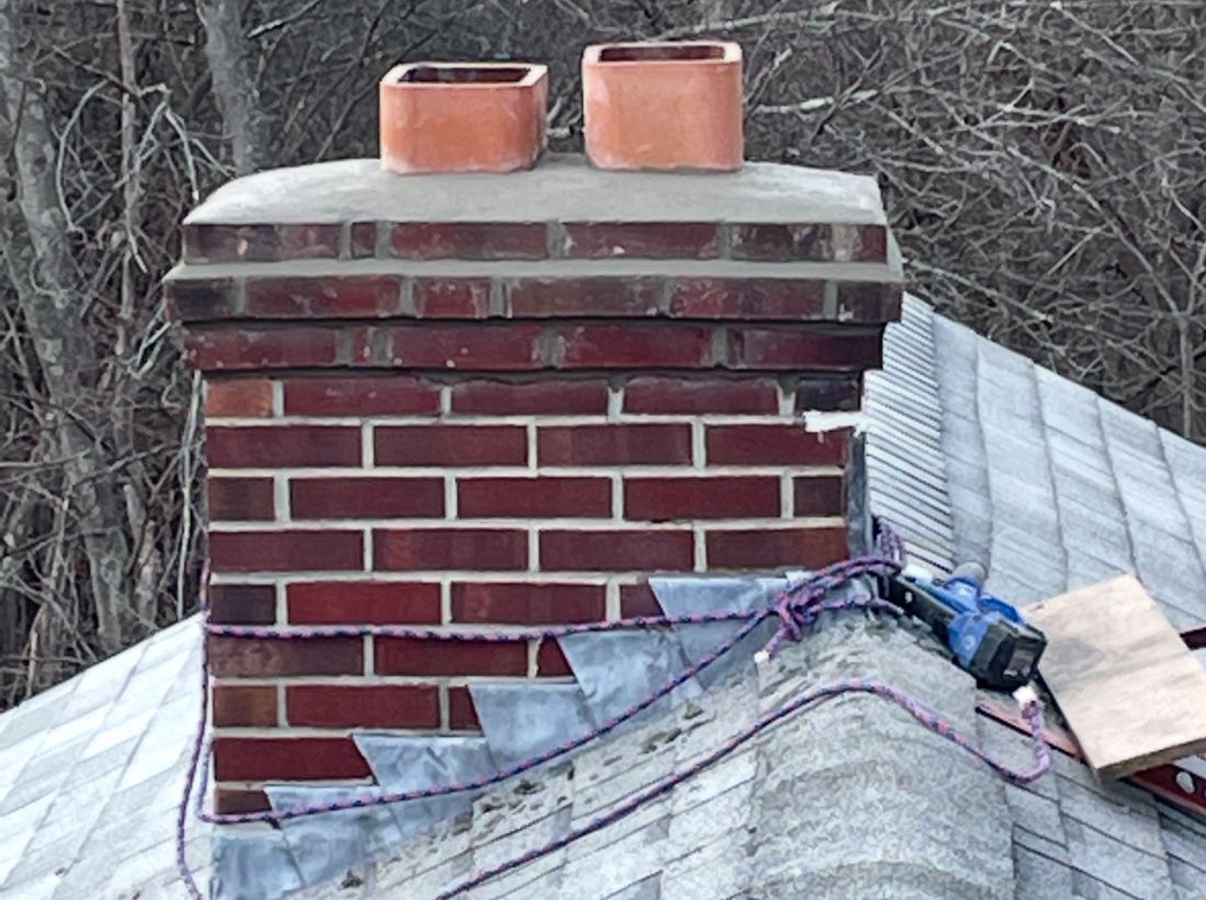 brick chimney being repaired on shingle roof house in MA